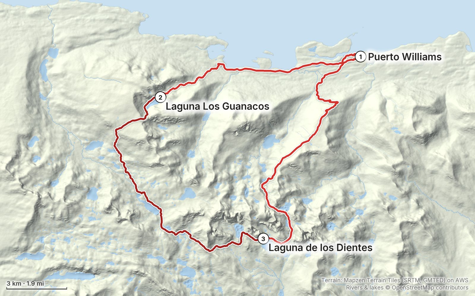Relief map of the Dientes de Navarino route: 3 days drawn in red with numbered day starts, labelled Puerto Williams, Laguna de los Dientes and Laguna Los Guanacos.