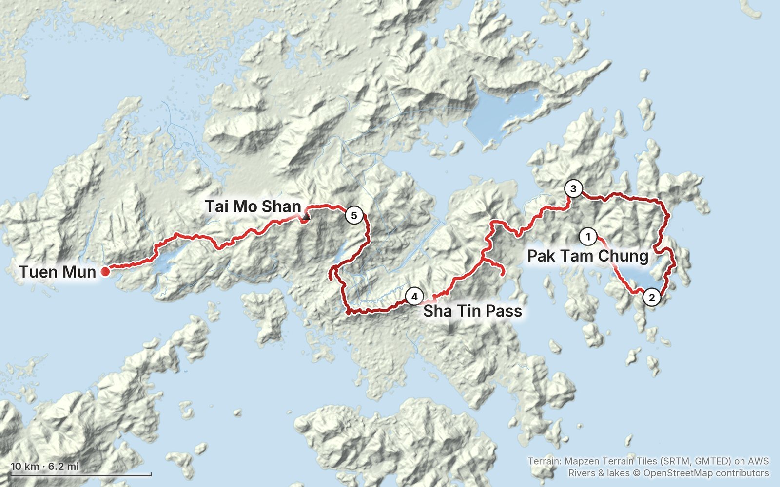 Relief map of the MacLehose Trail route: 5 days drawn in red with numbered day starts, labelled Pak Tam Chung, Tuen Mun, Tai Mo Shan and Sha Tin Pass.