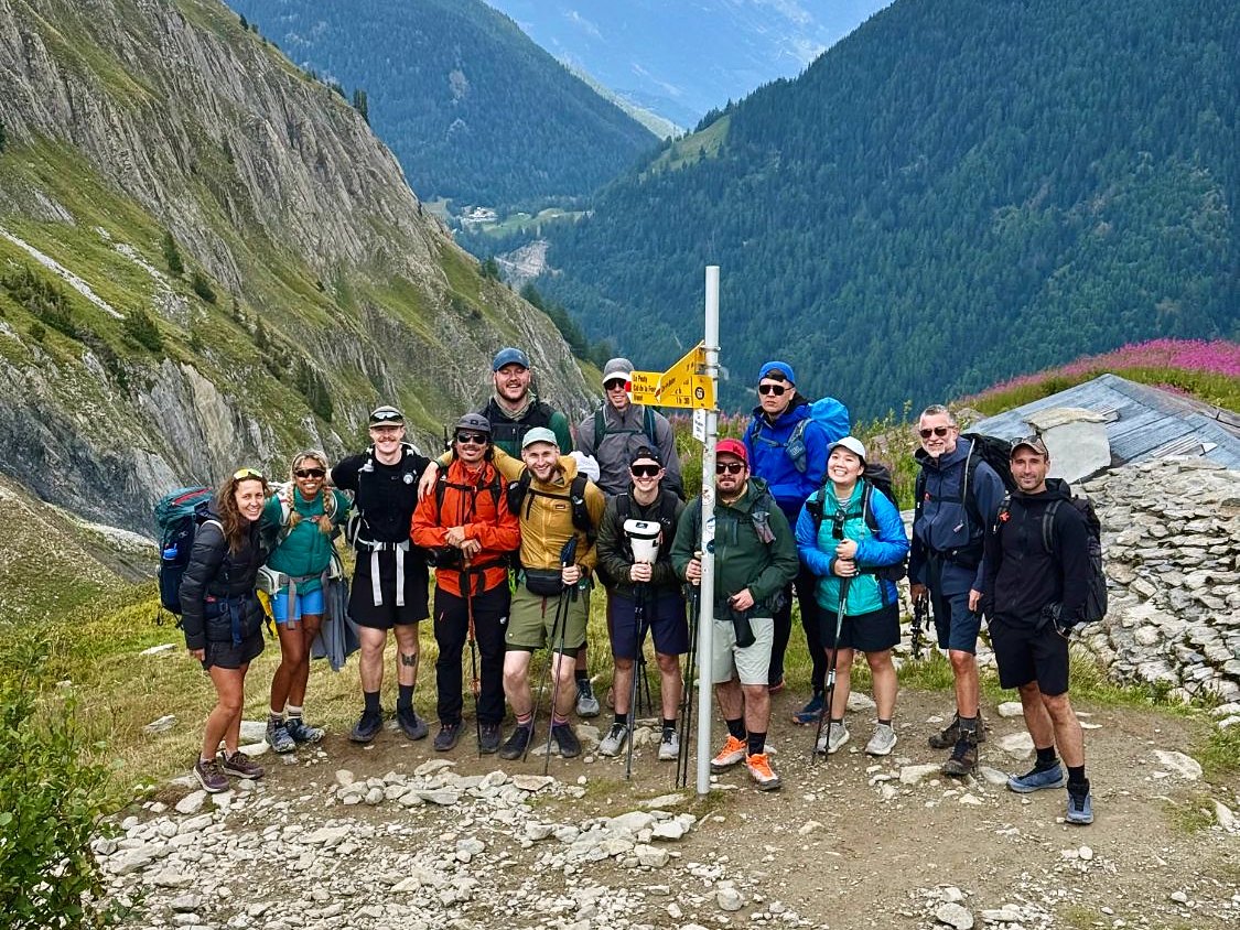 The 2025 Haute Route group at a trail sign near Trient