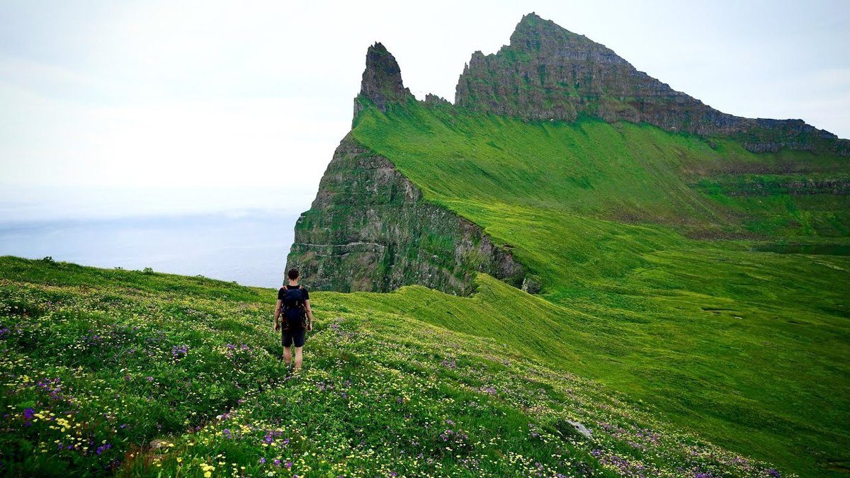 Hornstrandir, Iceland: a green slope under sea cliffs, from my Hornstrandir film's YouTube thumbnail